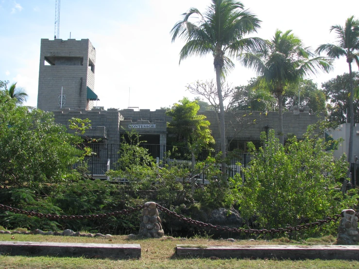 an old building near some trees and bushes