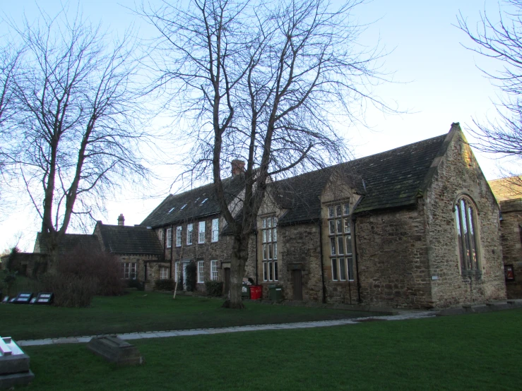 a stone house with a grass yard in front