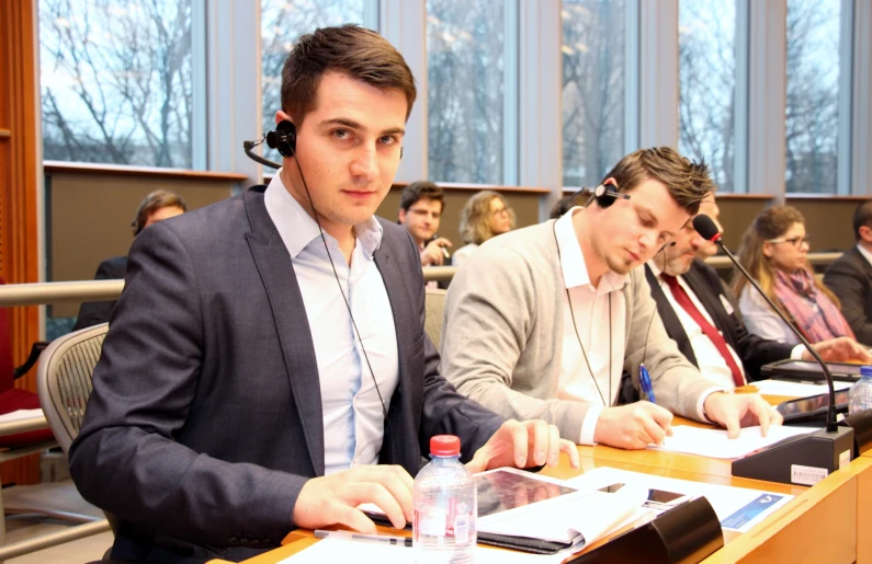 a group of people that are sitting in a meeting room