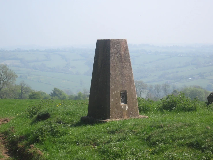 a lone stone obelisk in an open field