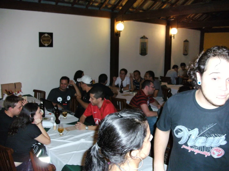a group of people sitting at long table in a dining room