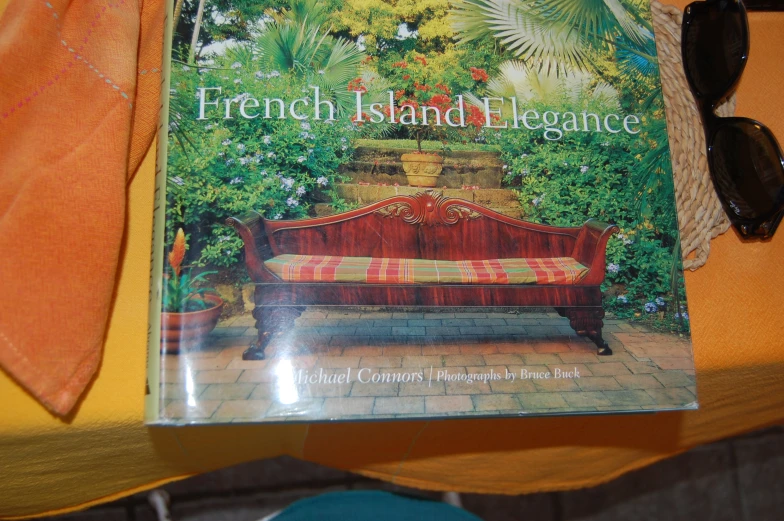 the cover of the book french island elegance sits next to a table