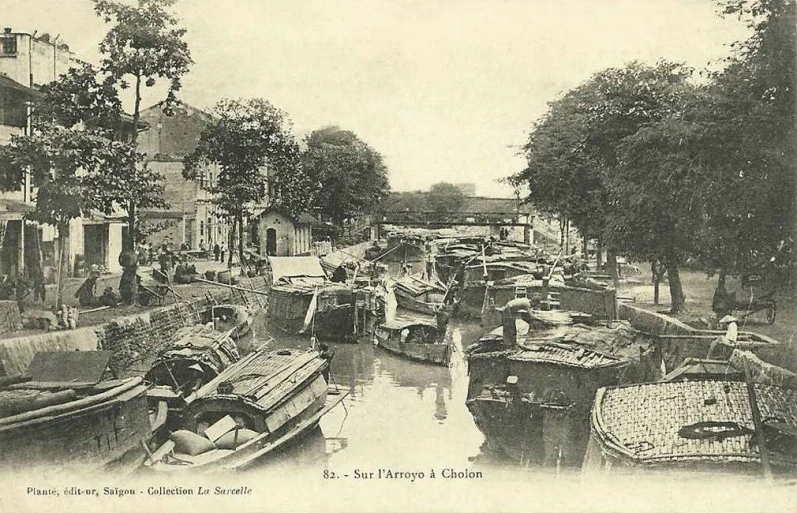 many boats lined up on the side of a river