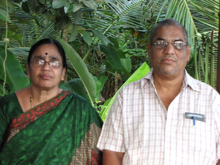 an indian couple in their traditional attire in a tropical setting
