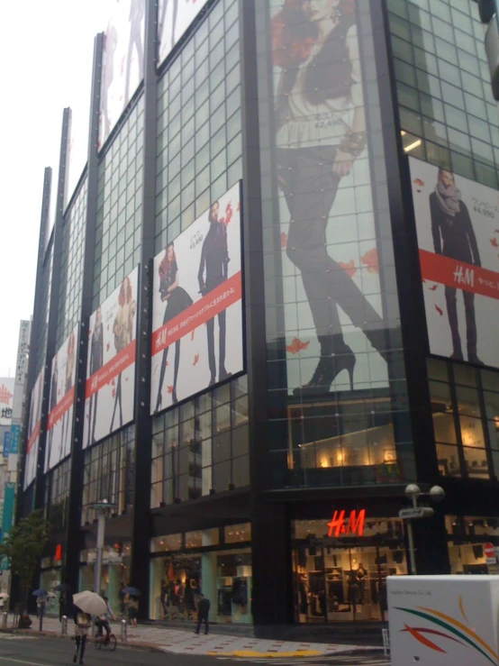 a giant picture of a person is reflected in the glass of a store