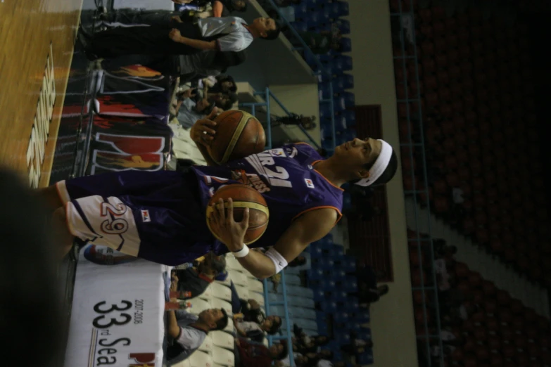 a man with a basketball on his hand is standing