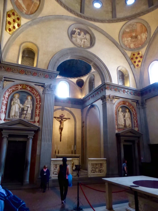 an interior of a church with people and altars