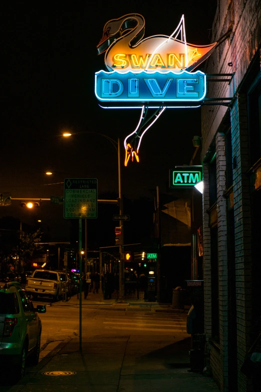 the sign for the pawn dive is lit up at night