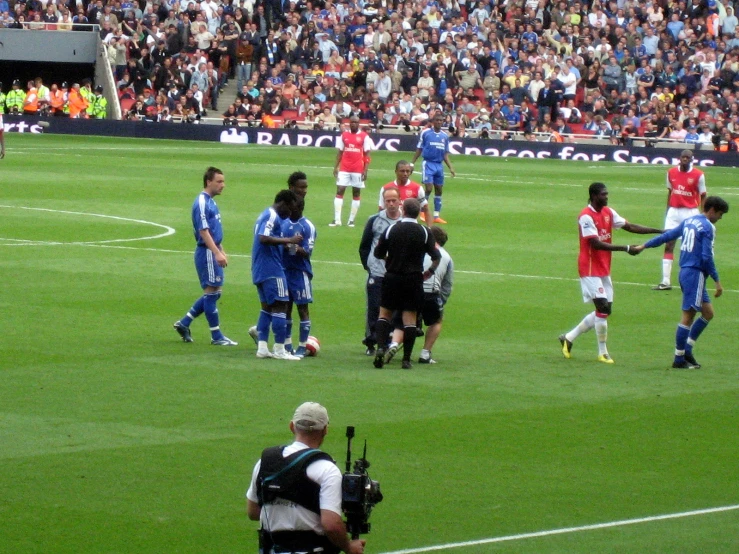 a crowd of people in the stands watching a soccer game