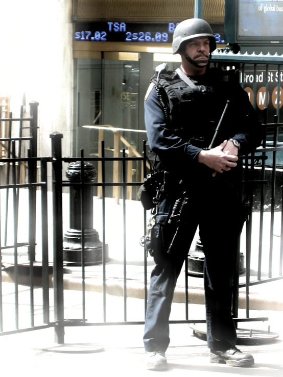 a security officer standing by a fence in front of a building