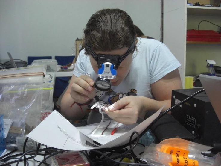 a person looking through a piece of paper with a goggles on