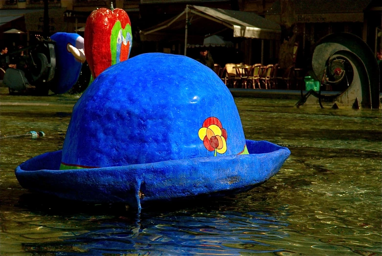 a blue boat with colorful designs in the water