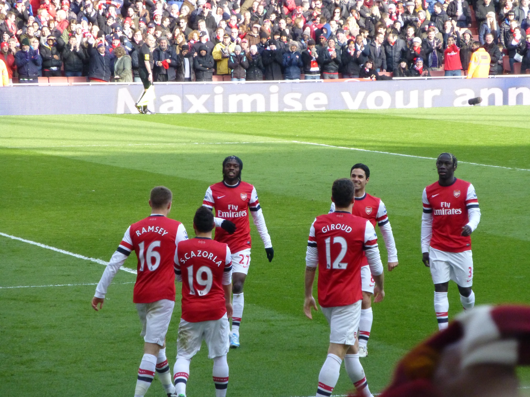 a soccer team huddles together on the field