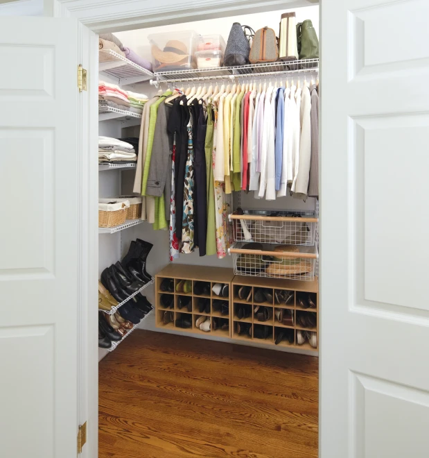 a room has a closet with a bunch of shoes and bags