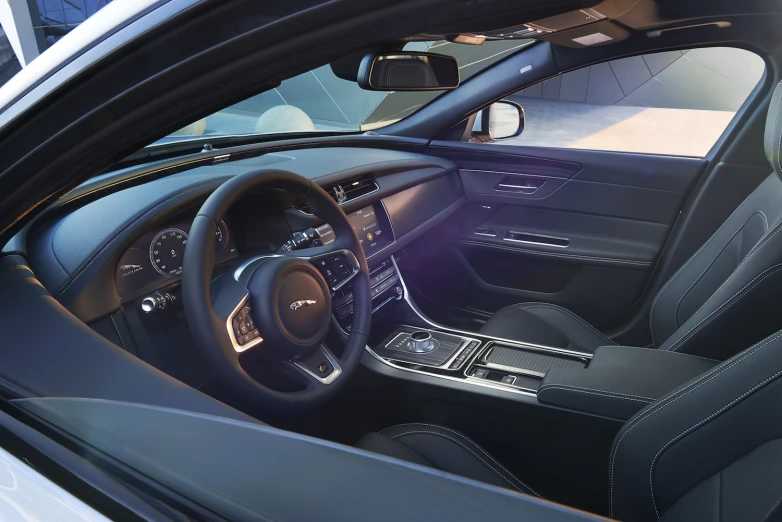 the interior of a car in gray leather and a blue dash board