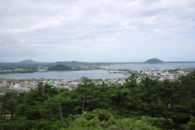 a small lake is seen from top of a hill