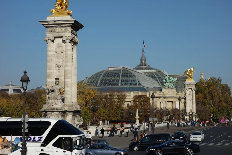 traffic on a busy street in front of a glass domed building