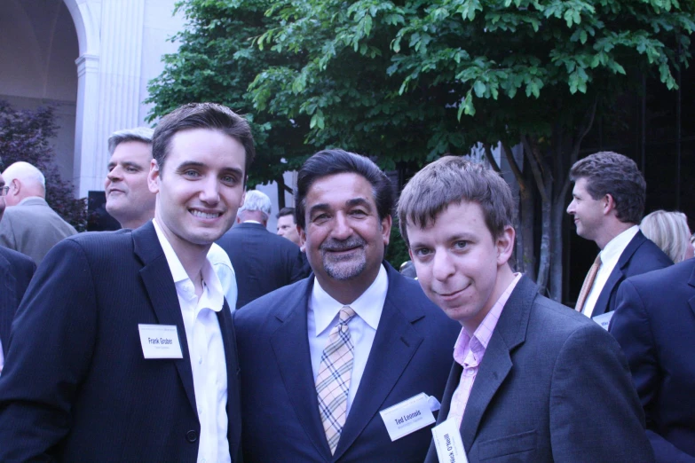 four men standing together at an event