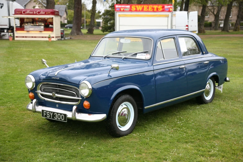 the old car is parked in the yard