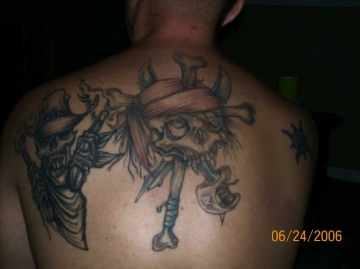 a man wearing a pirate tattoos on his back
