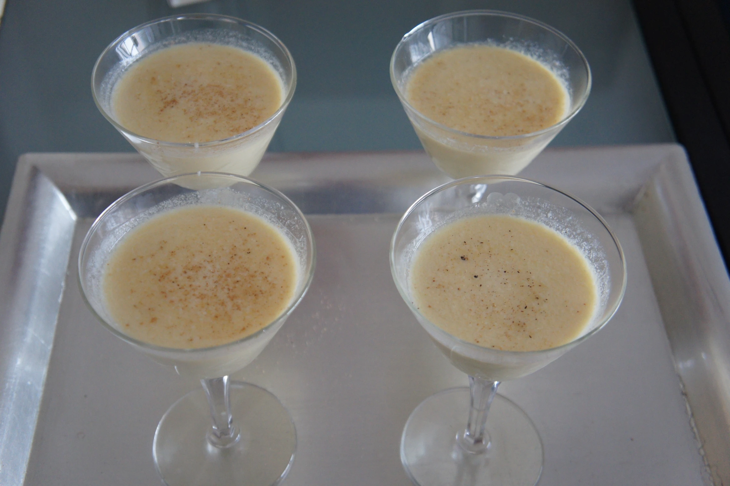 three small martini glasses on a silver tray