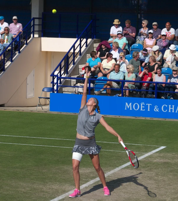 a woman on a tennis court is holding a tennis racket and a ball