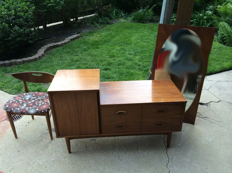 an empty desk and chair with a blurry image on the back