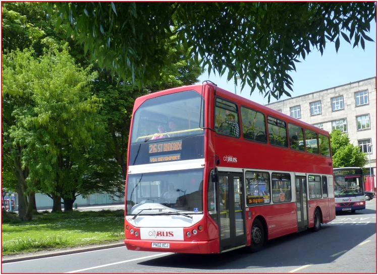 a big red bus that is going down the street