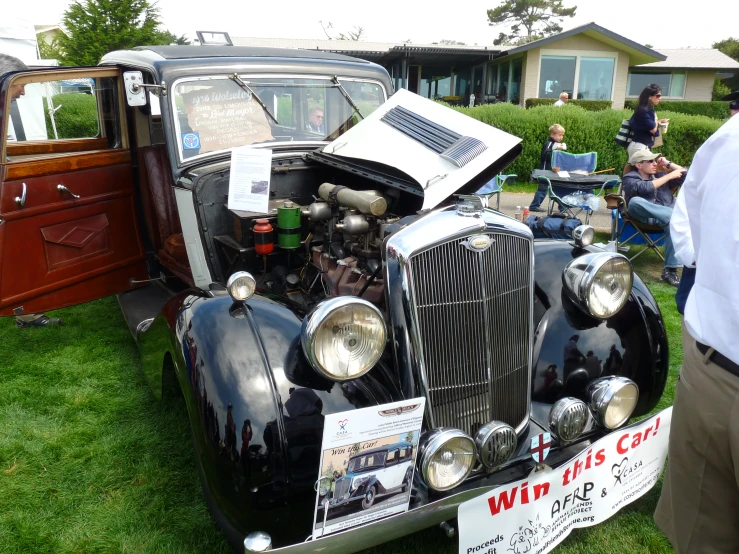 an old car with a large engine and bonnet