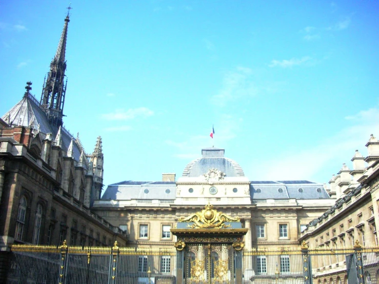 an entrance to a large building with many windows and columns