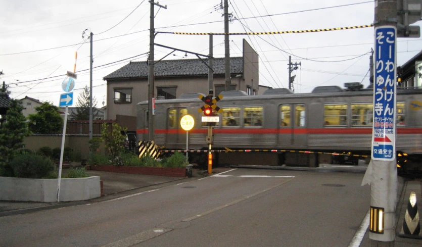 a train crossing in an asian city street