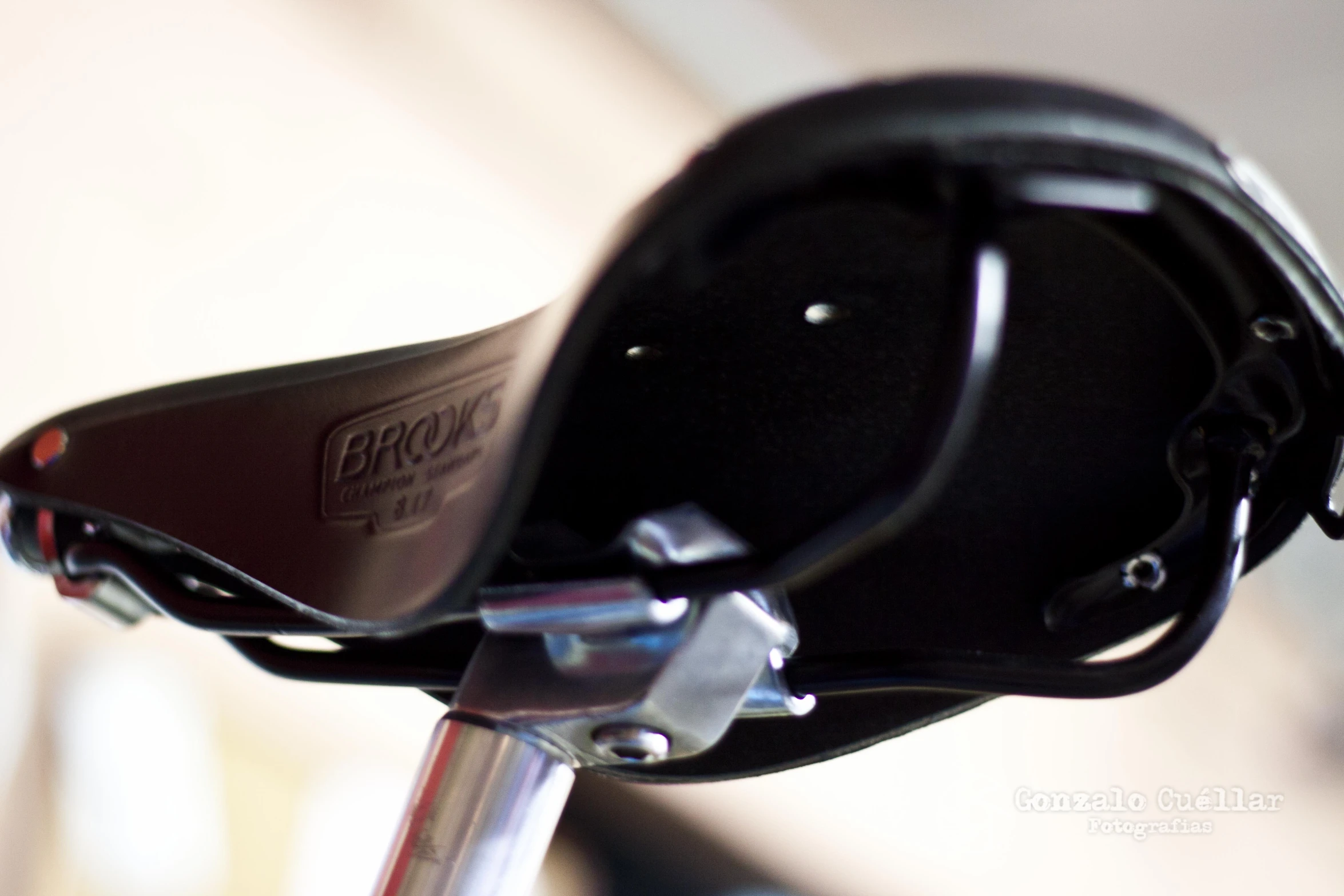 the handlebars of a bicycle with a black leather case