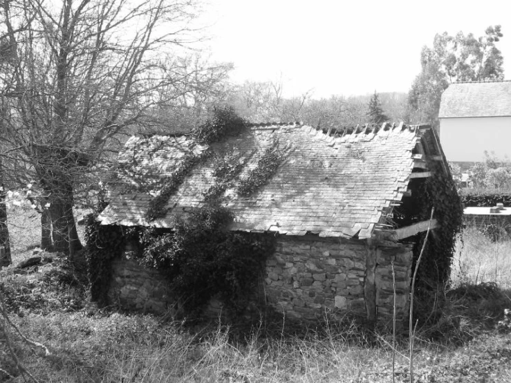 an old stone cottage with a thatched roof