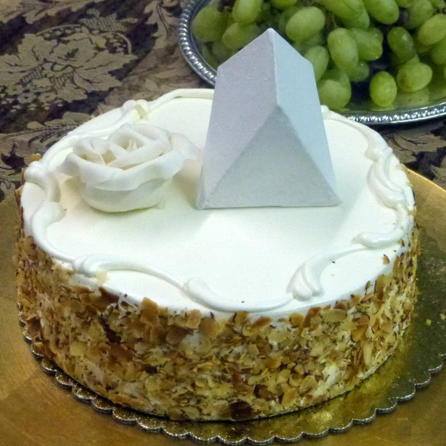 a cake with an origami figurine sitting on top