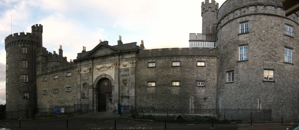 an old castle building with gated parking