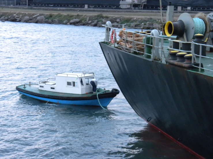 a small boat in the water with some equipment on top of it