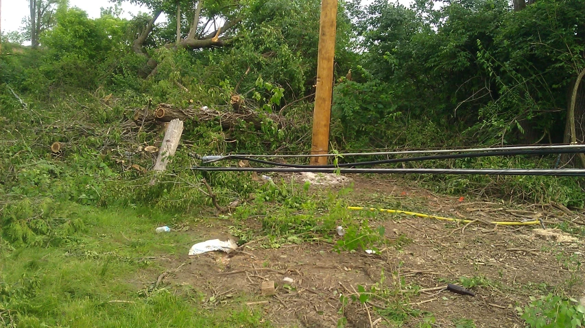 an uprooted street sign in the middle of a grassy area