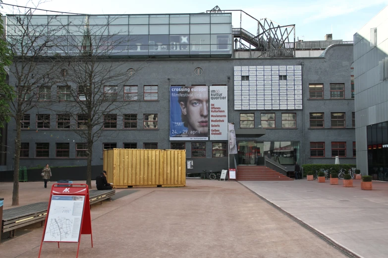 a building with multiple posters on it in front of a building