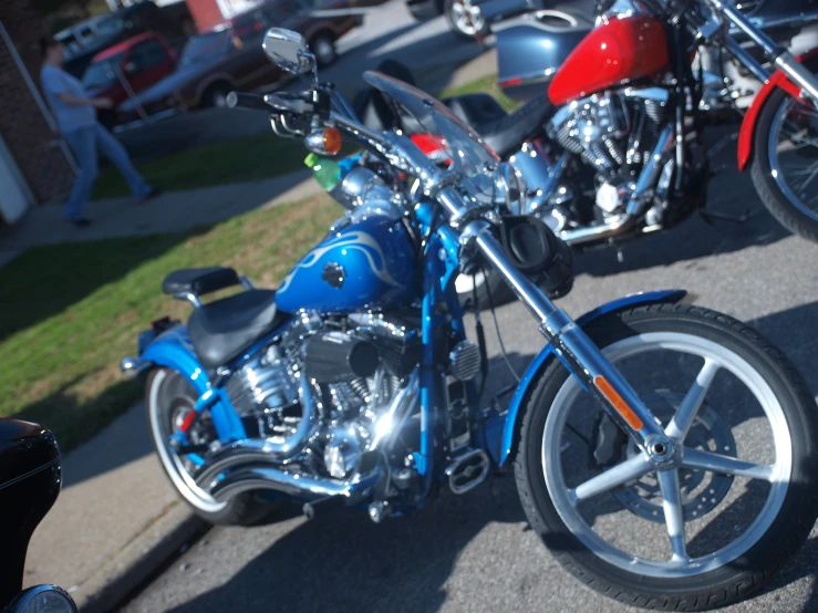 a blue and red motorcycle parked next to another bike