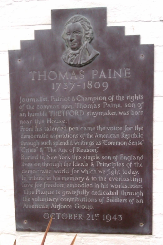 a memorial plaque at thomas paine's marker