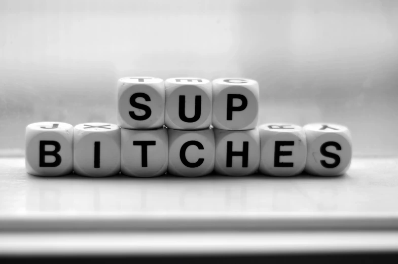 dices that say sup bitches sitting on a counter