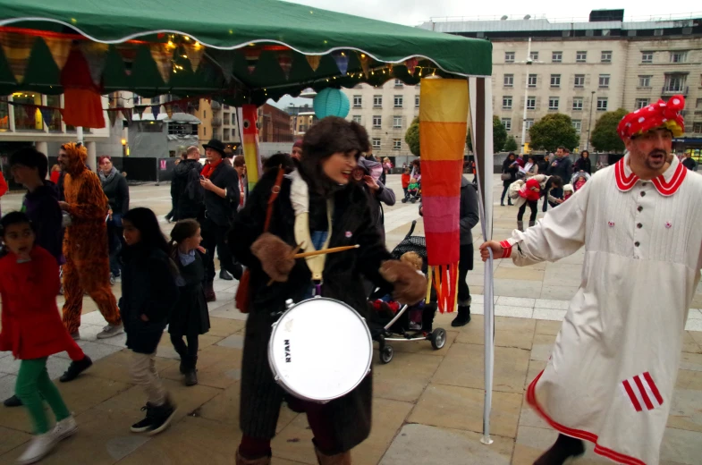 two men dressed in folk costumes are walking through a parade