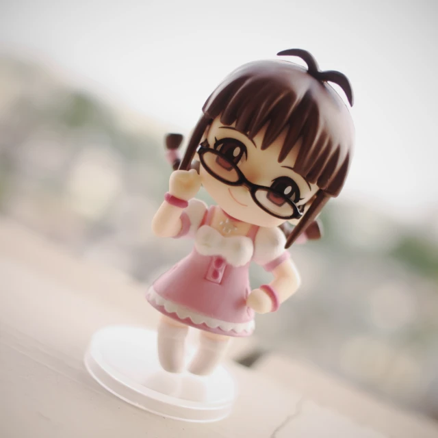 an adorable little girl figurine on a wooden table