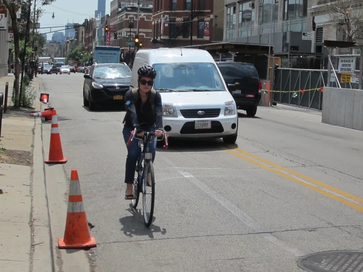 the woman is riding her bike on the street