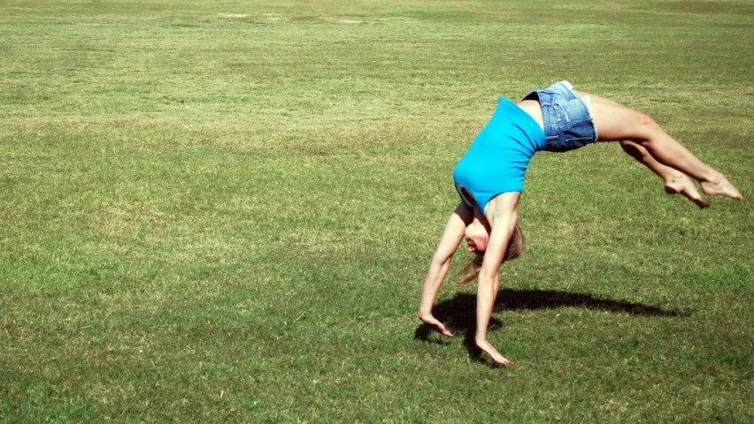 a man is in mid air after catching a frisbee