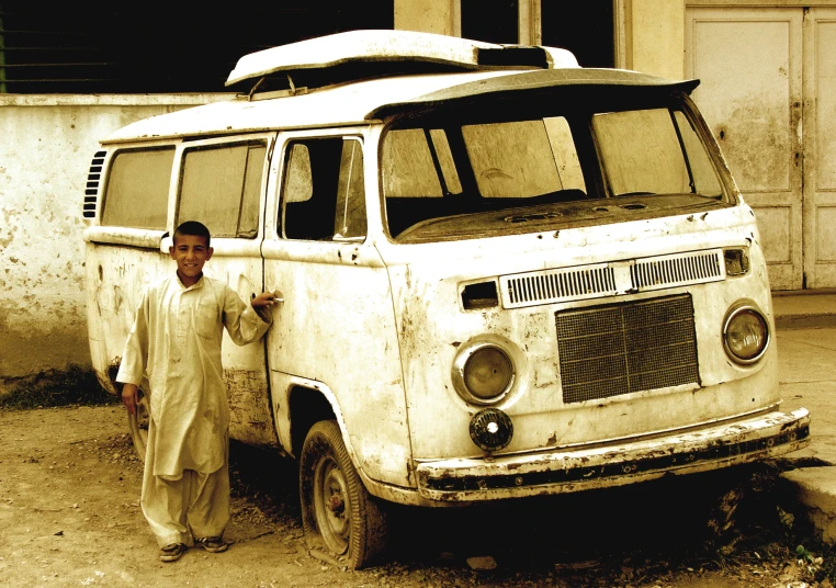 a person standing next to an old van