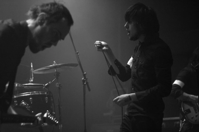 two men with guitars in black and white po