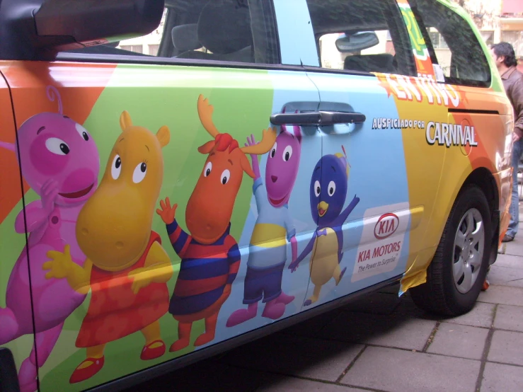 a brightly painted car has characters on it