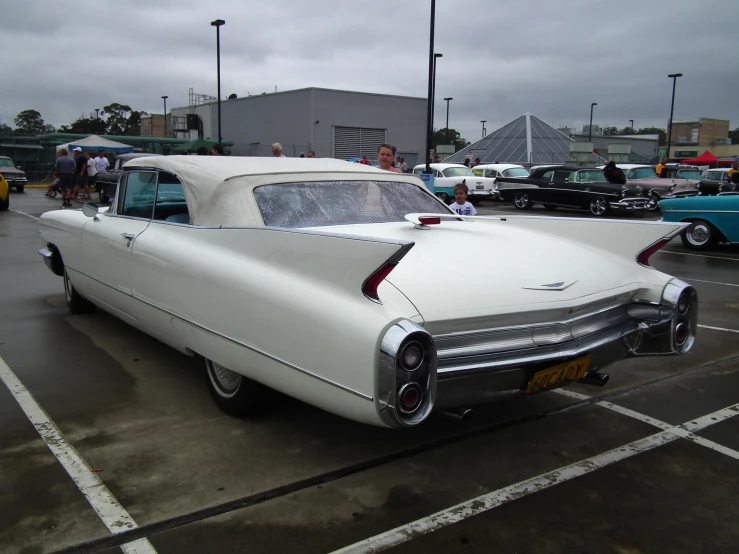 an old style car is parked in the lot