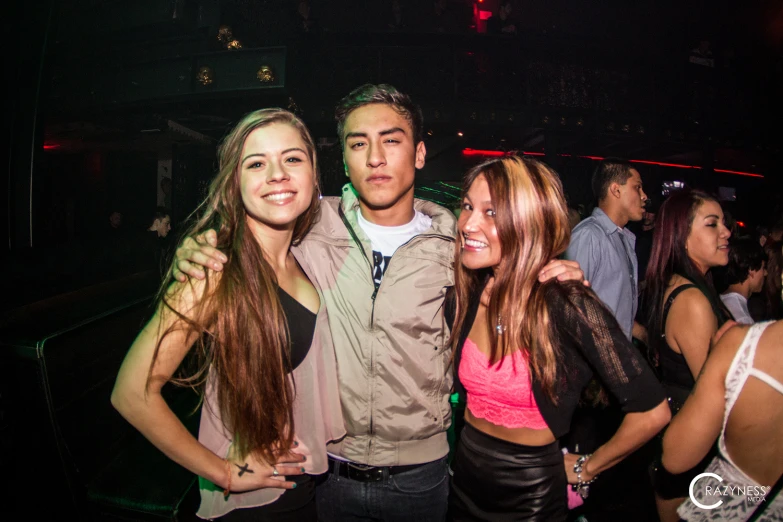 a group of people in a club posing for a picture